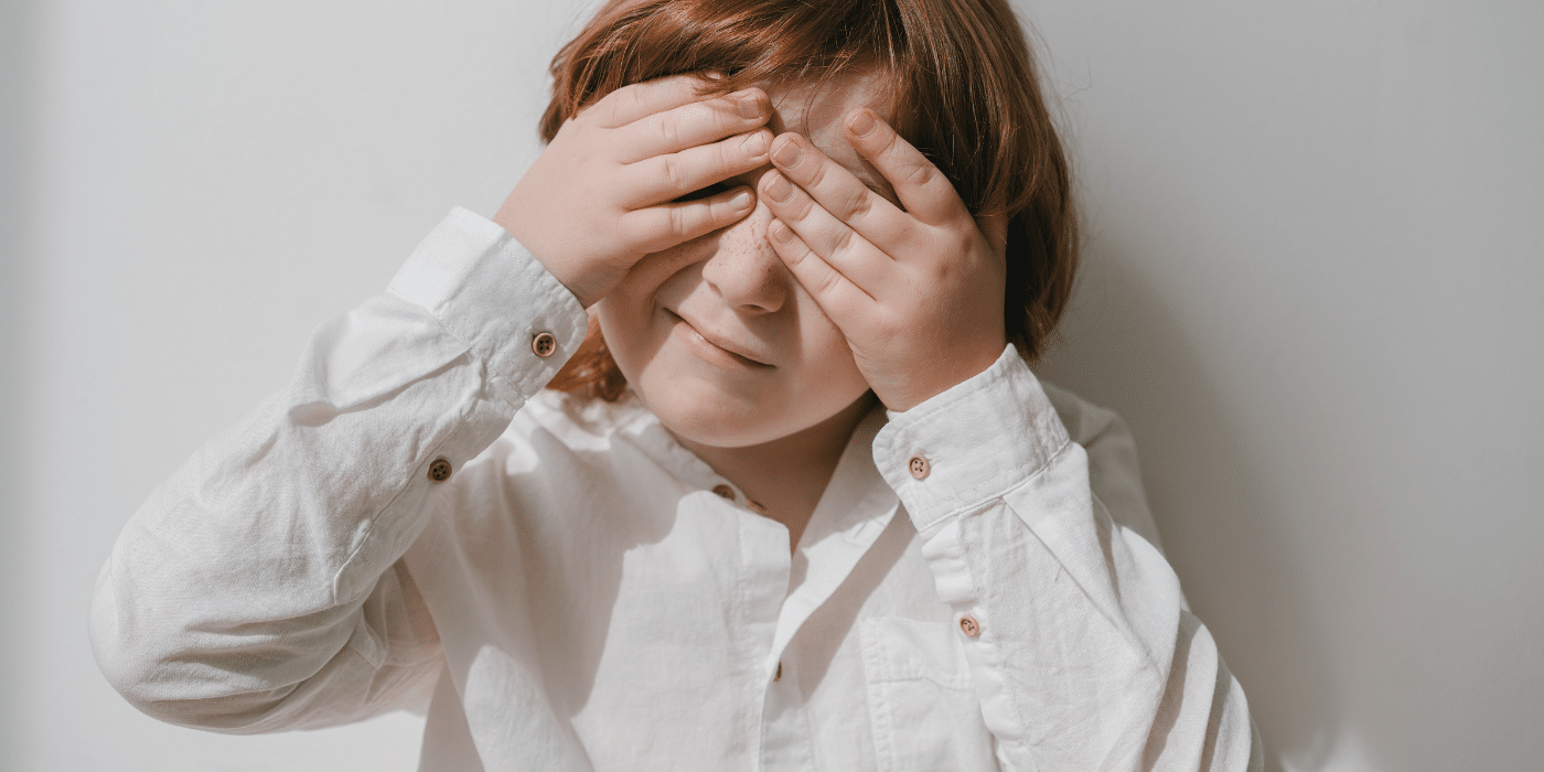 Young child rubbing sore eyes