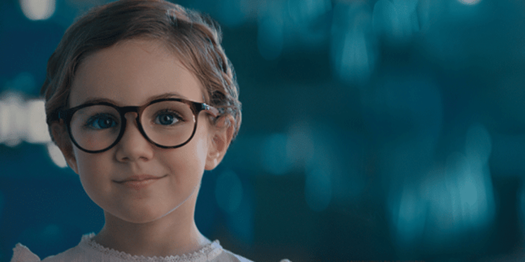 Young boy wearing myopia control glasses